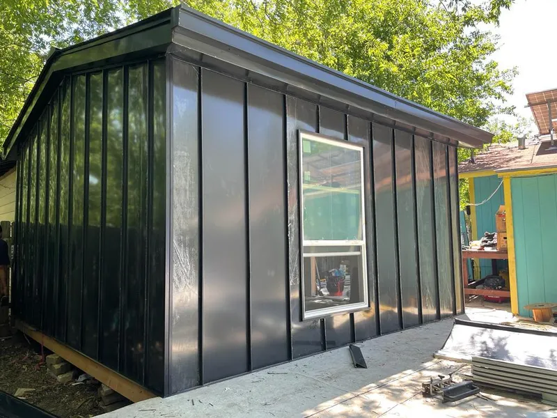 Black standing seam metal wall panels for Roof Inspection in Katy