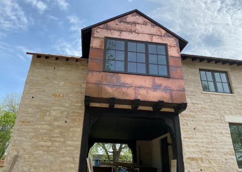 Copper metal panel facade on a stone building for Metal Roof Coating in Katy